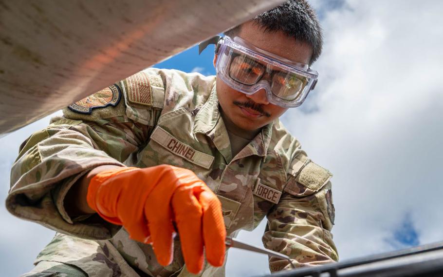 U.S. Air Force Airman 1st Class Gage Chinel, 18th Logistic Readiness Squadron laboratory technician, gathers raw fuel samples from a Defense Logistic Agency pipeline.